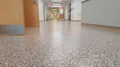 an empty room that has a shiny and metallic stain design of epoxy flooring