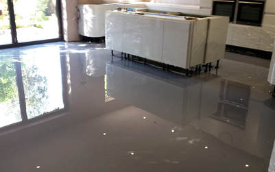 a room with a very shiny epoxy flooring that the floor almost like a mirror.